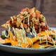 Ghost Pepper Nachos (Lamplight Lounge Boardwalk Dining at Disney California Adventure Park) - Charred ghost pepper-marinated chicken, smoky ghost pepper cheese sauce, black bean purée, avocado tomatillo salsa, and seasoned tomatoes.